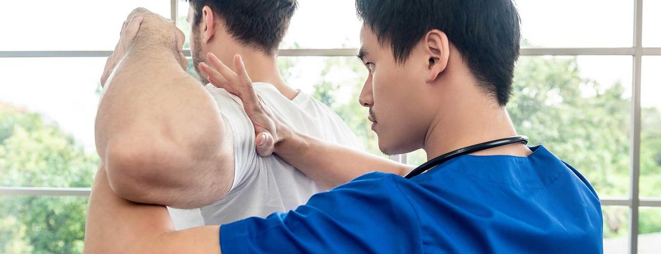 Therapist working with patient's shoulder