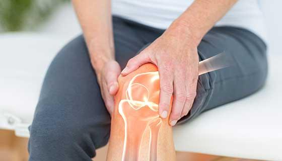 Woman holding knee in pain